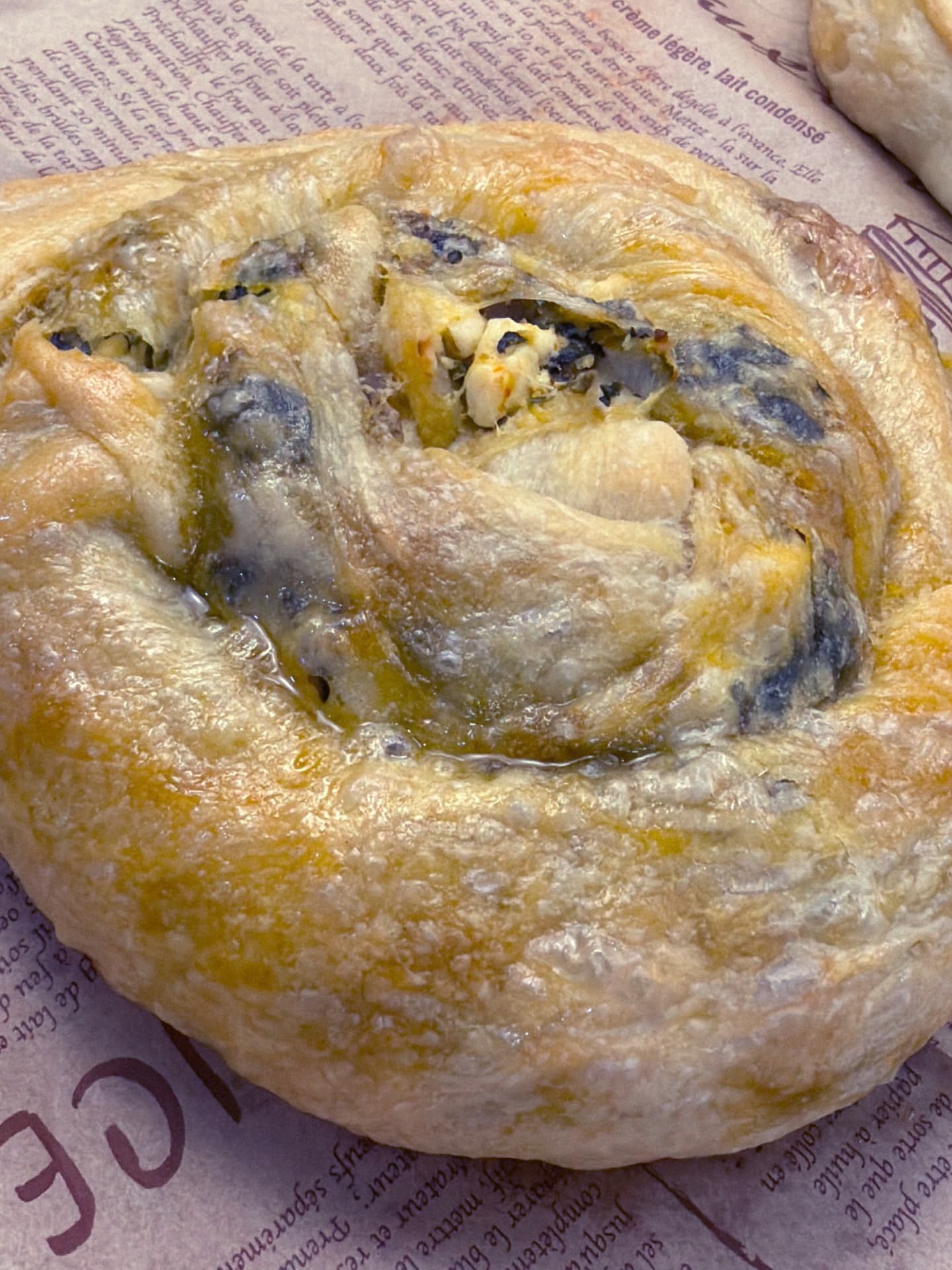 An individual spiral banitsa on printed parchment paper