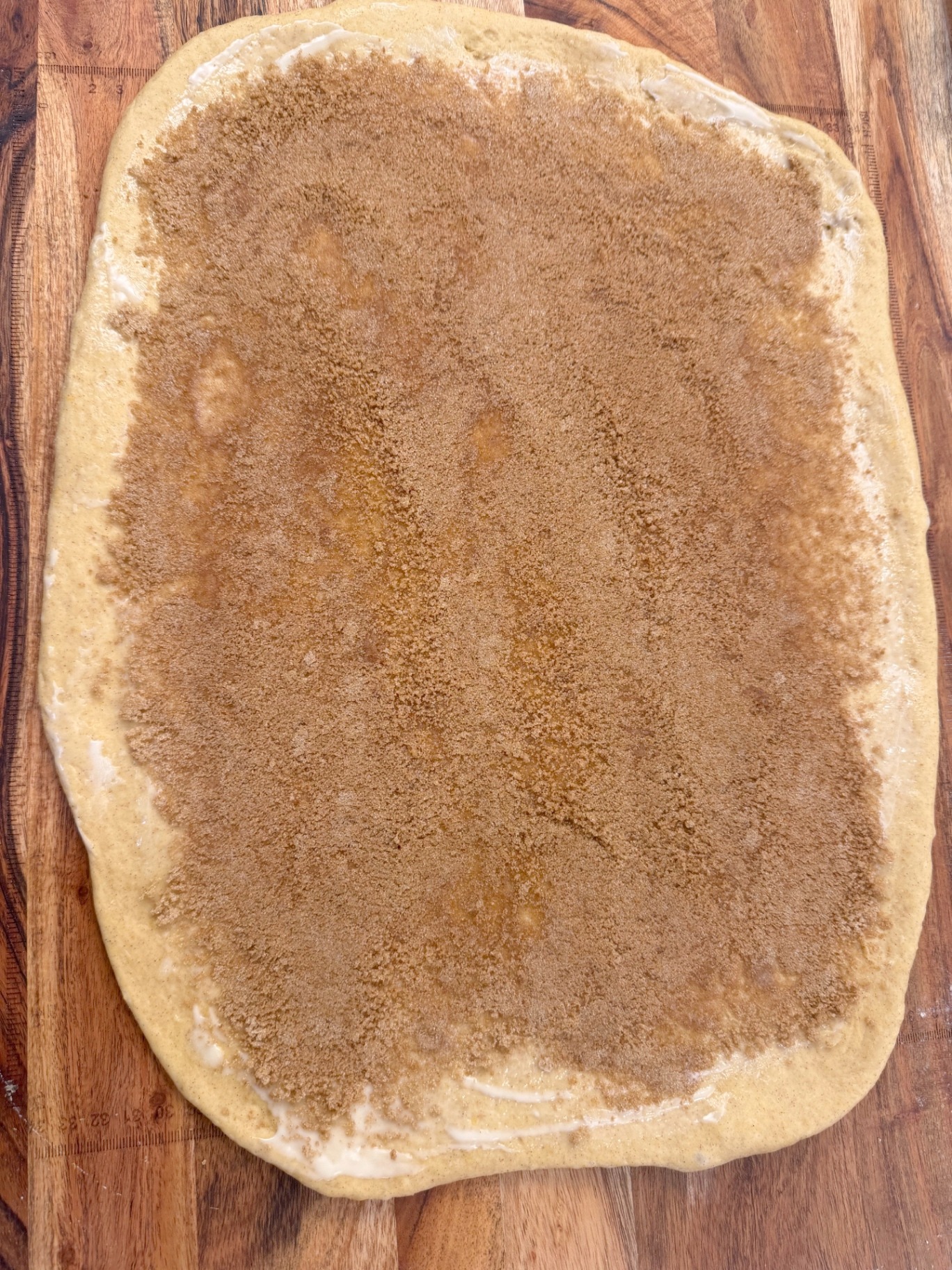 Dough rectangle covered with cinnamon sugar filling