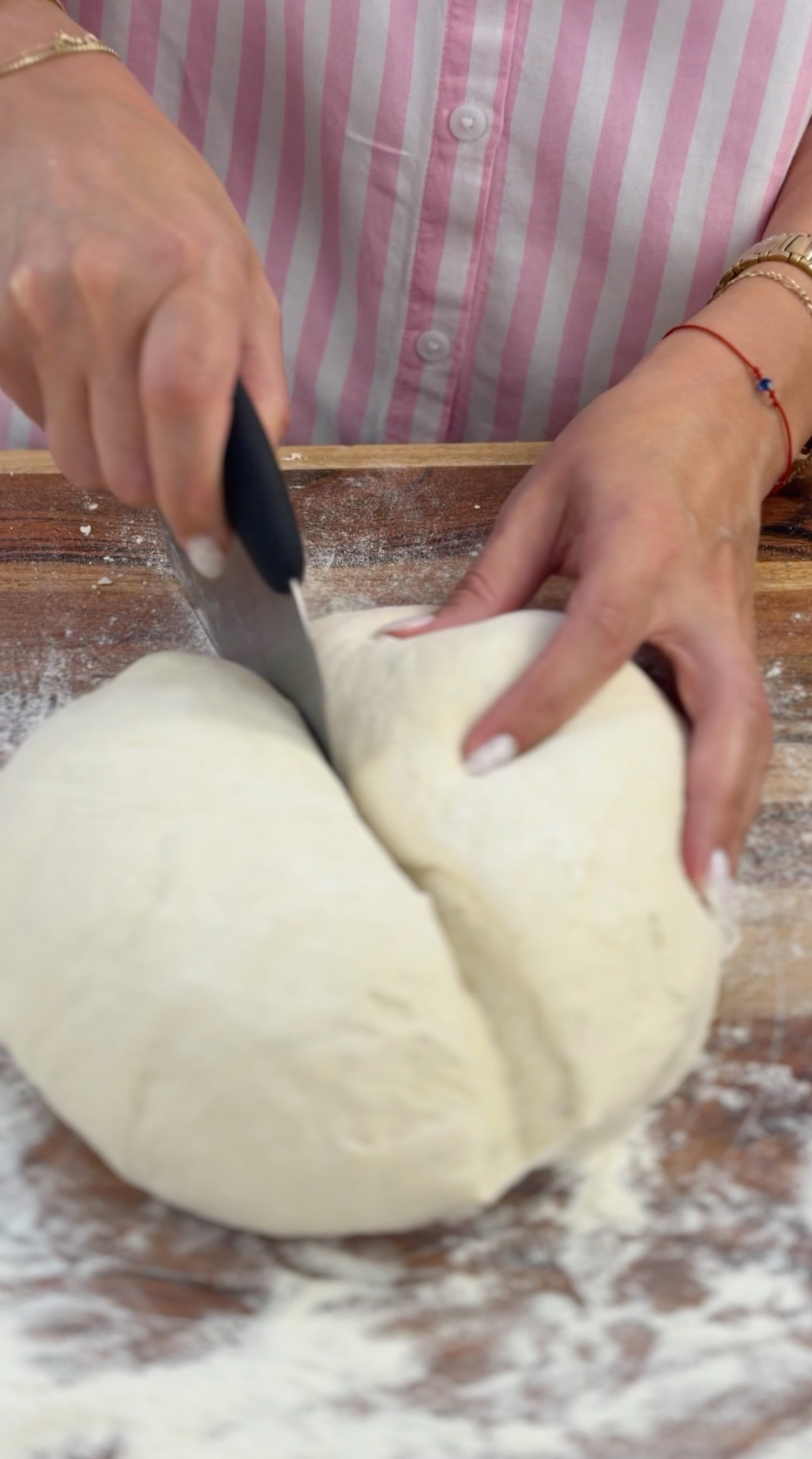 Cutting the risen dough into pieces with a knife