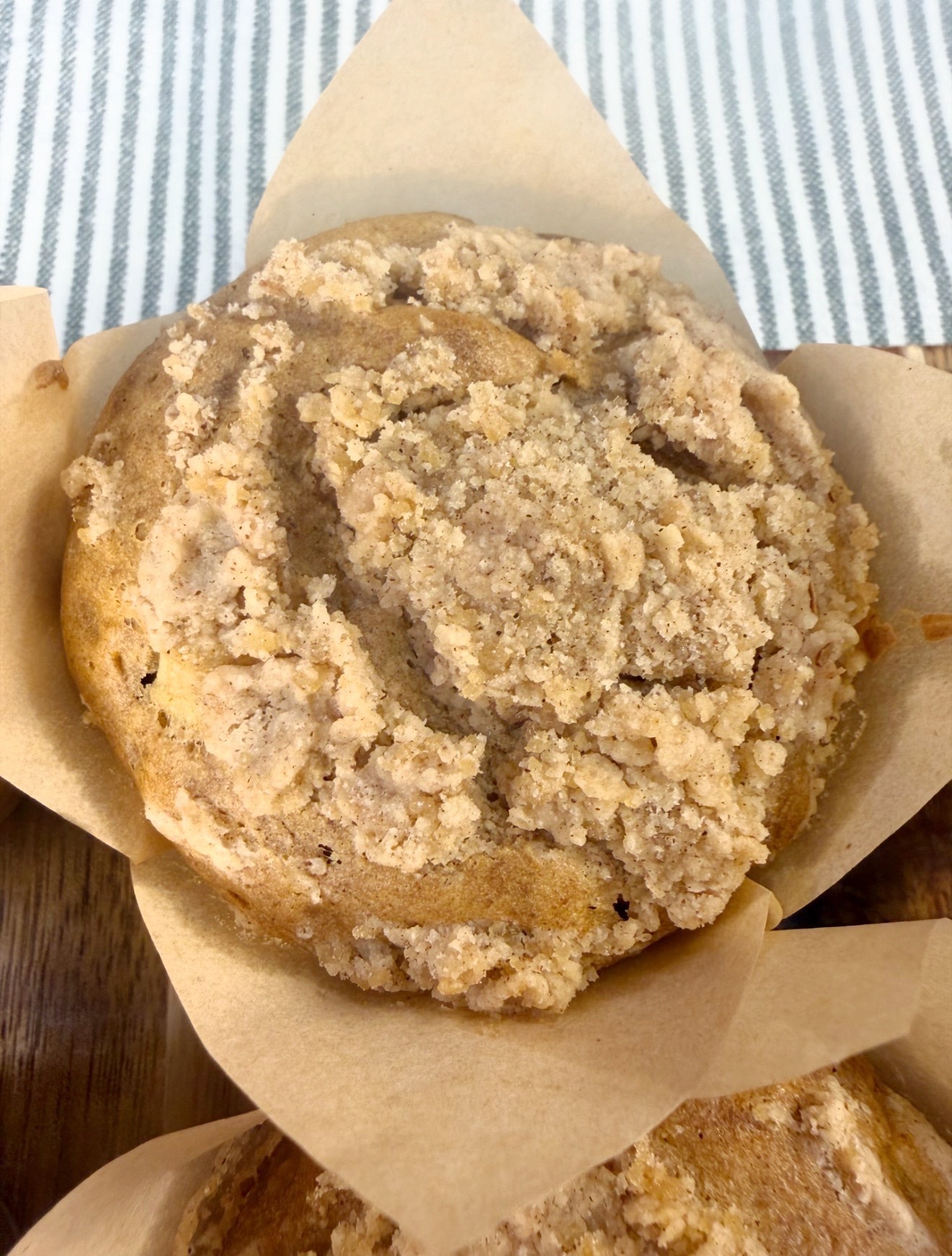 Close-up of the golden crumble topping on an apple muffin