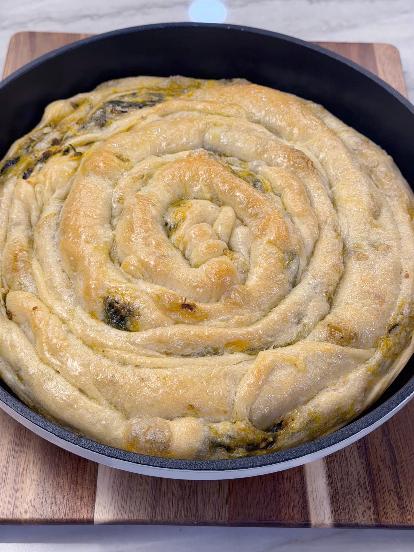 The baked banitsa spiral, glossy and deeply golden