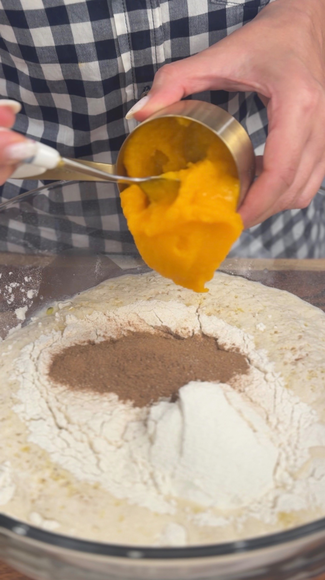 Adding pumpkin purée to the mixing bowl